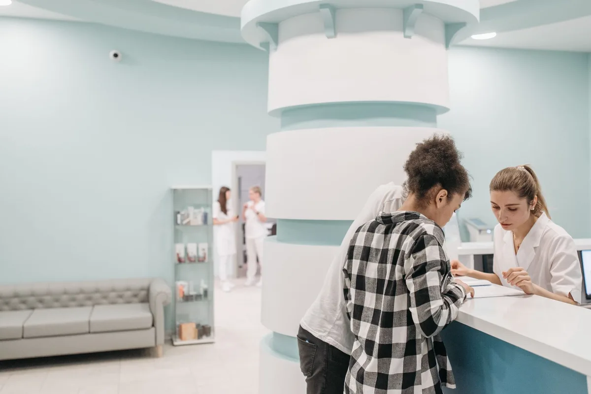 A medical office reception area with a phone at the front desk.