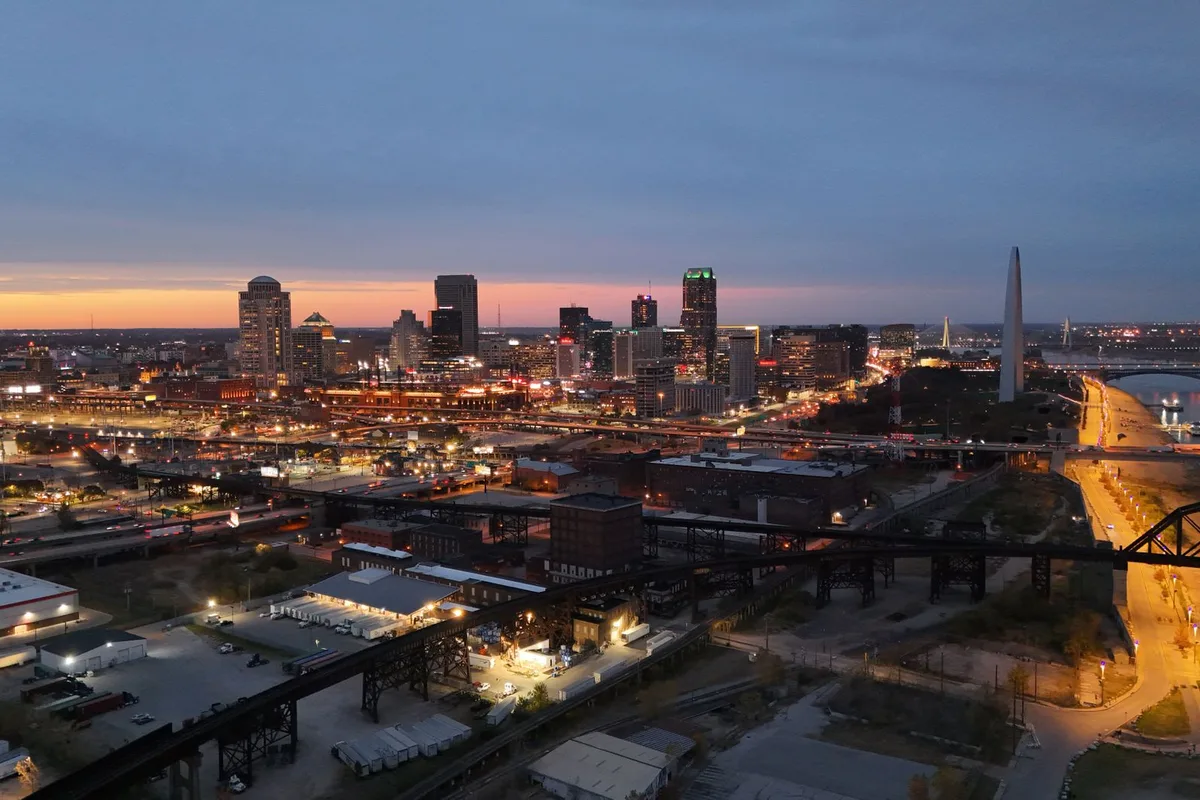 A bridge crossing the Mississippi River between Illinois and the St. Louis skyline.