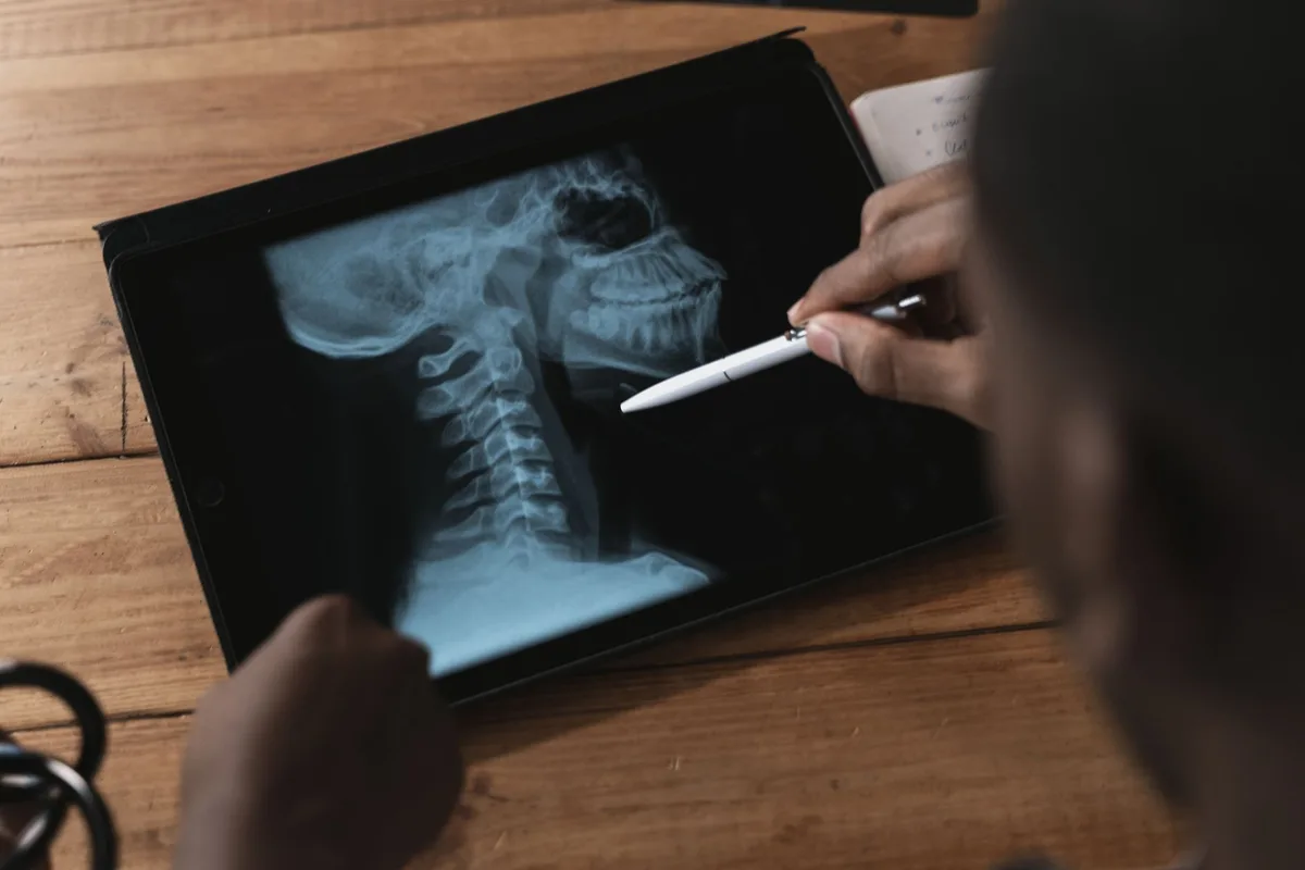 A physician performing an image-guided sympathetic nerve block procedure.