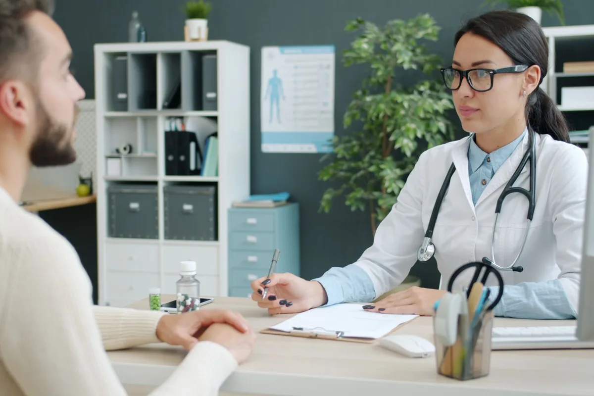 A physician taking a patient's history during an initial consultation.
