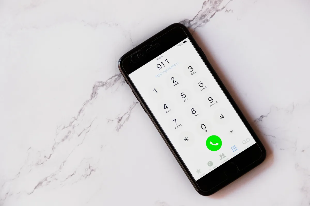 A smartphone keypad with 911 entered, ready to call.